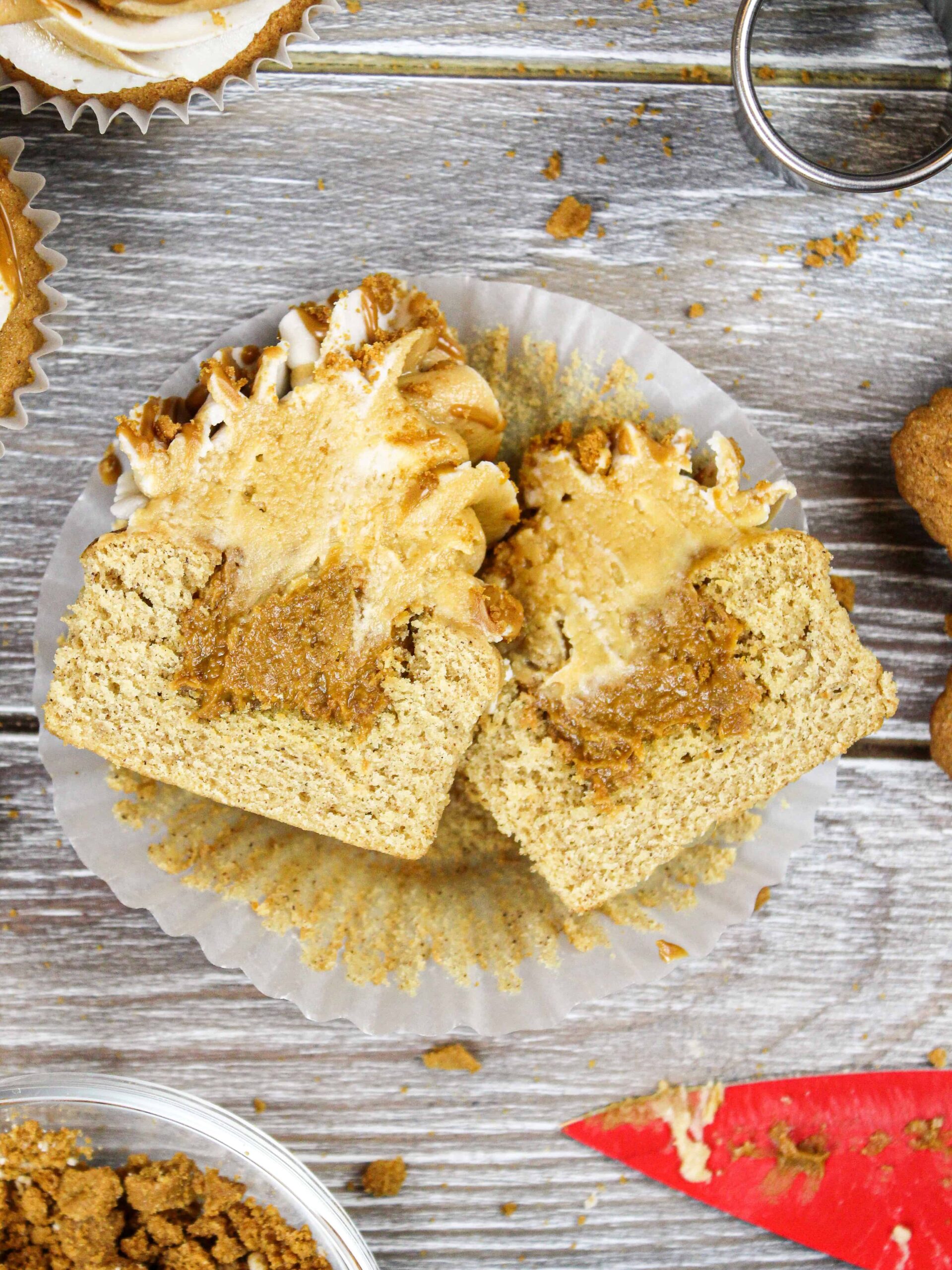 image of a biscoff cupcake cut open to show its cookie butter filling in the center