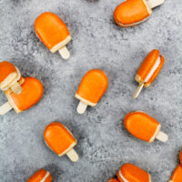 image of mini orange creamsicle macarons filled with orange creamsicle buttercream