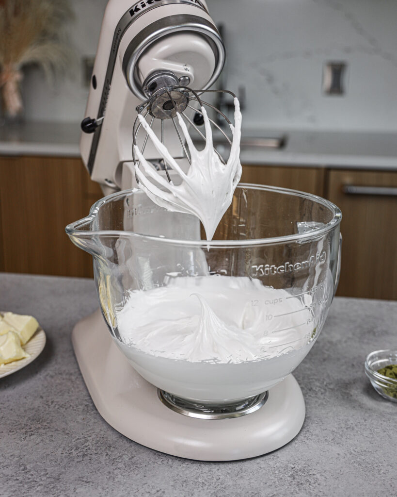 image of egg whites and powdered sugar that have been whipped to stiff peaks to make a not too sweet buttercream frosting