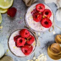 image of raspberry overnight oats that are topped with fresh raspberries and lemon zest