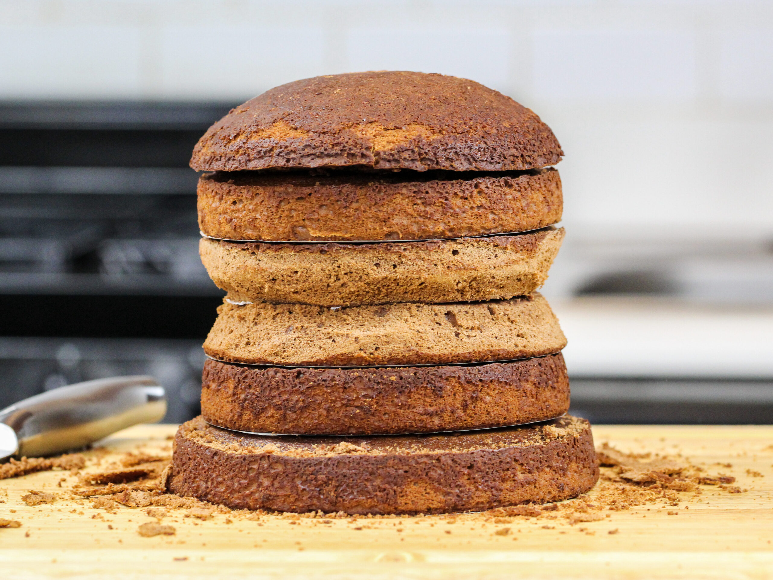 image of chocolate cake layers being trimmed to make a sloth cake