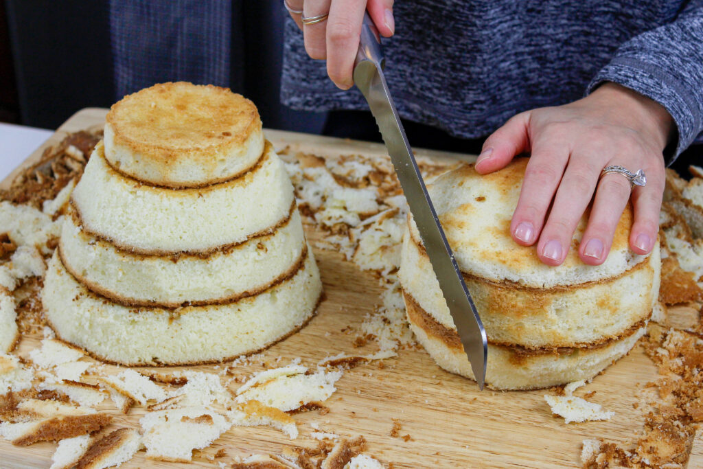 image of fluffy vanilla cake layers being trimmed down to make a polar bear shaped cake