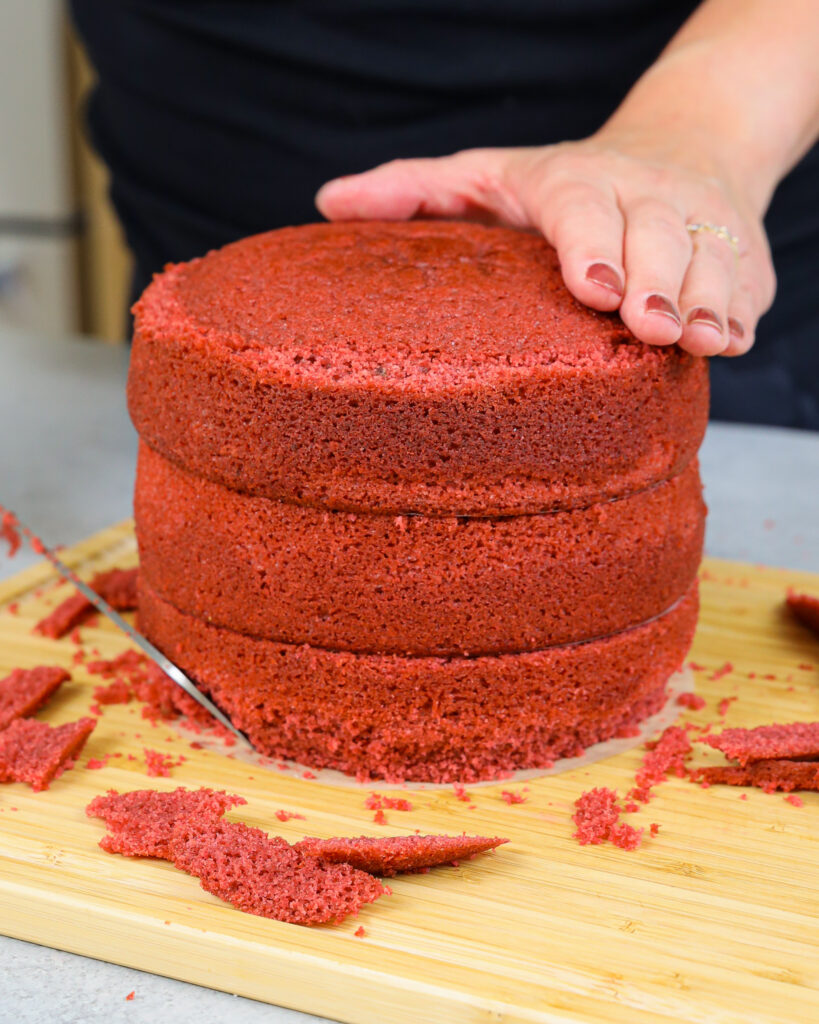 image of 6 inch cake layers being trimmed to make a cocomelon cake