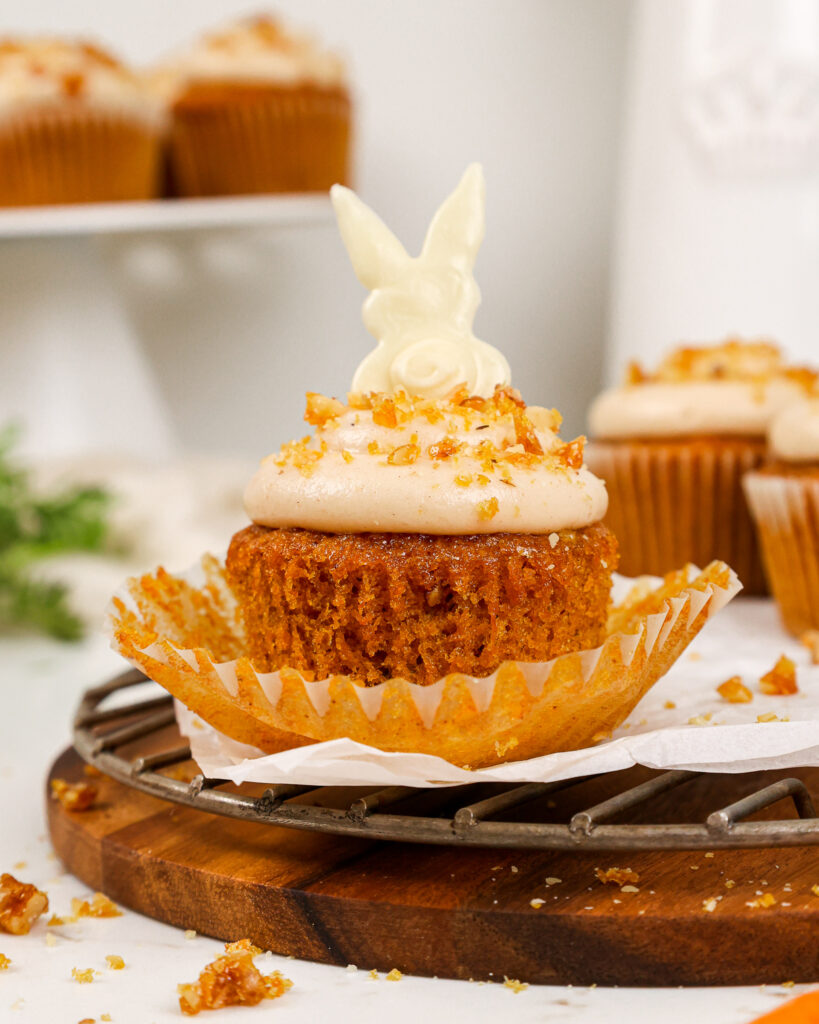 image of a carrot cake cupcake that's been decorated with a cute white chocolate bunny for Easter