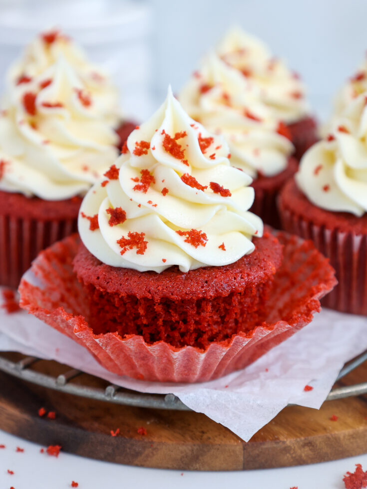 image of a moist red velvet cake that's been unwrapped and frosted with cream cheese frosting