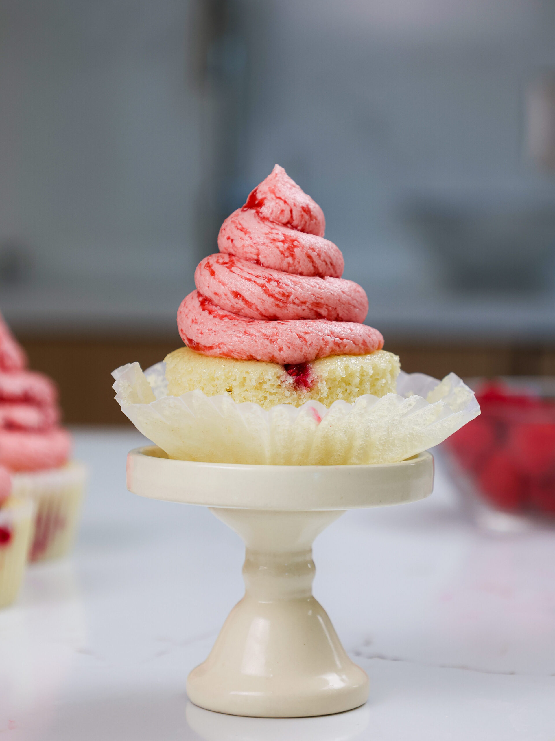image of a raspberry cupcakes made with a vanilla cupcake base and raspberry jam buttercream