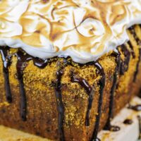 image of image of smores banana bread decorated with a chocolate drizzle and toasted marshmallow topping