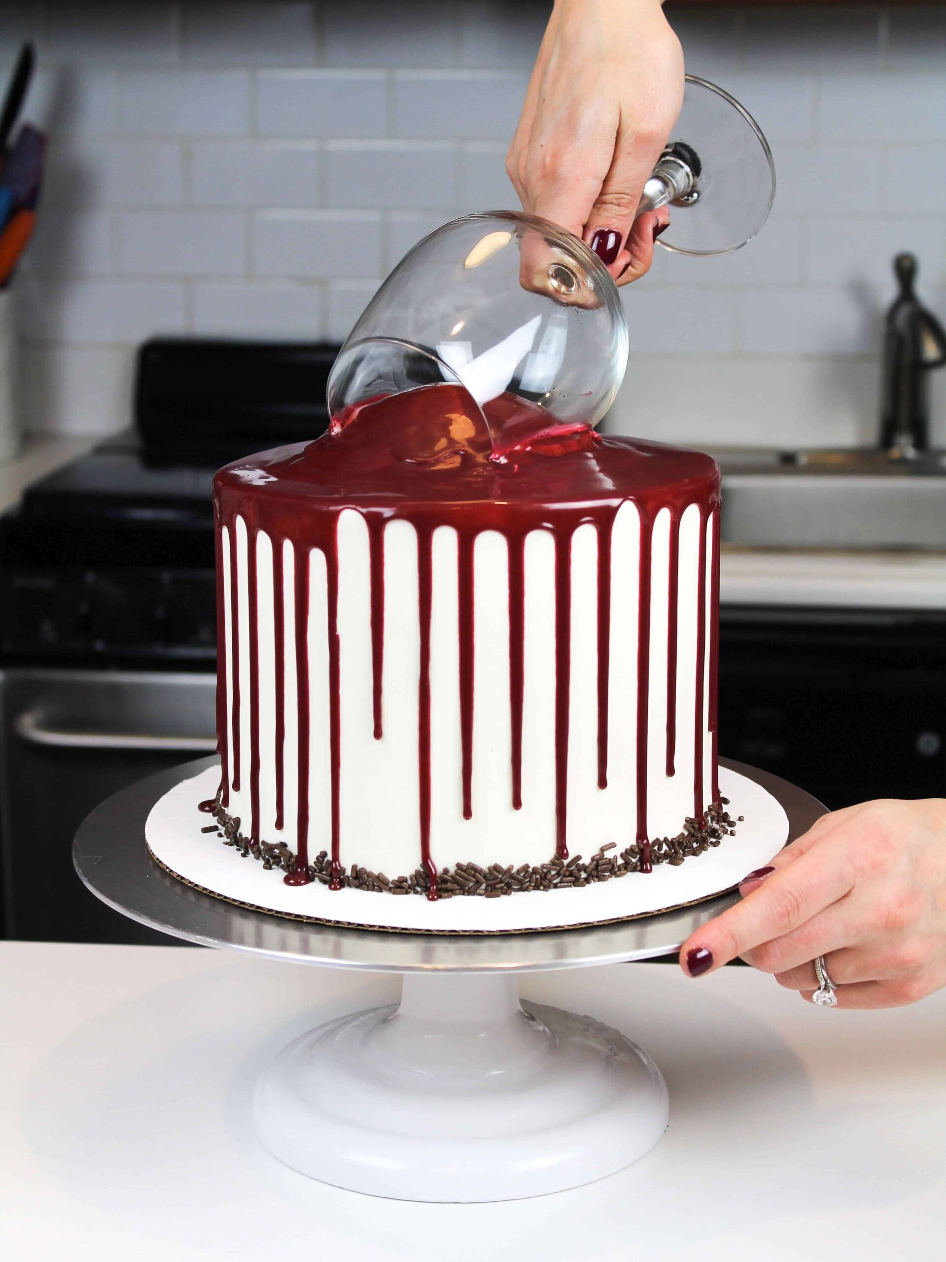 image of adding the wine glass to the top of a red wine chocolate cake