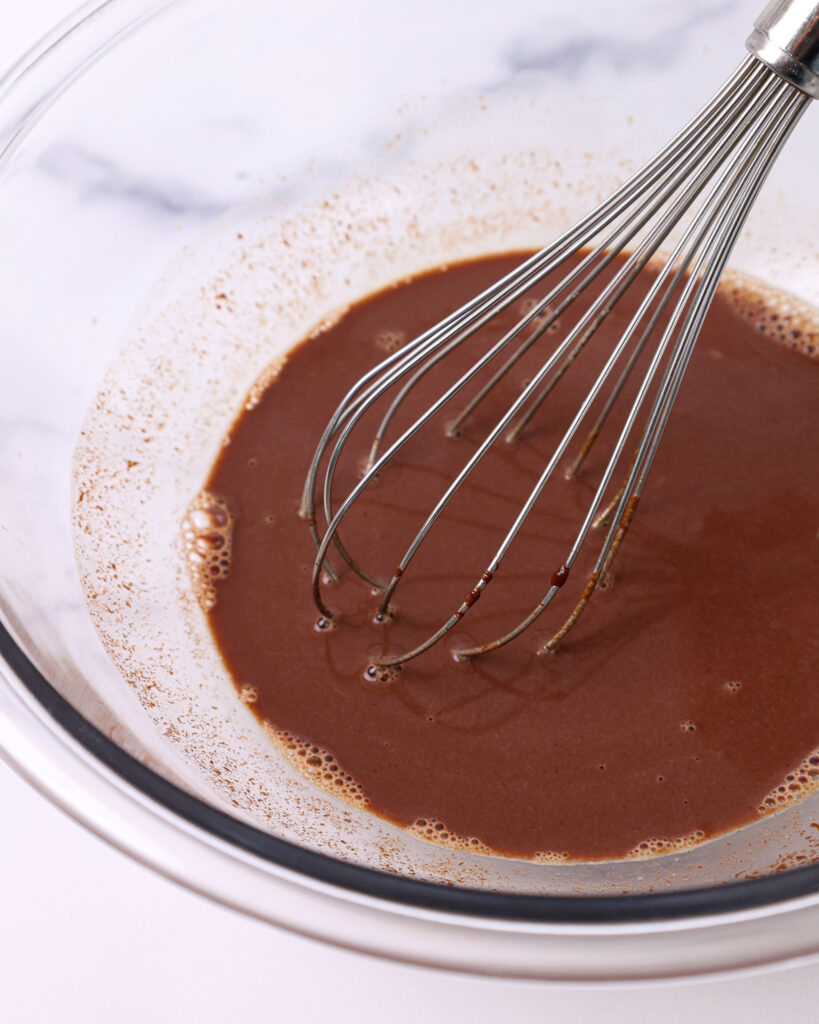 image of water and espresso and chocolate being whisked together