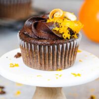 image of a chocolate orange cupcake decorated with chocolate orange buttercream frosting